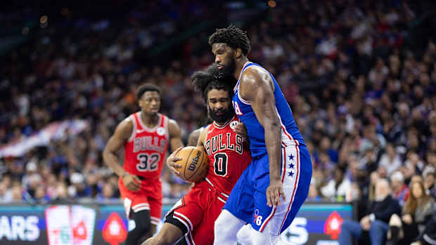 Chicago Bulls guard Coby White (0) drives against Philadelphia 76ers center Joel Embiid (21) during the third quarter at Wells Fargo Center.